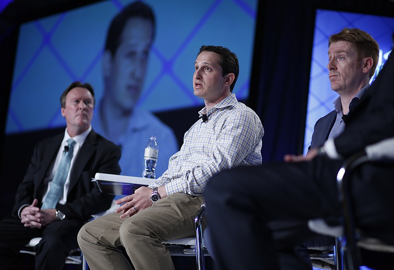 Jason Robins, center, CEO of DraftKings website, speaks on a panel at the Global Gaming Expo in Las Vegas in this Sept. 29, 2015 file photo. Nevada regulators have ordered daily fantasy sports sites like DraftKings and FanDuel to shut down, saying they can't operate in the state without a gambling license. The state's Gaming Control Board issued a notice Thursday, Oct. 15, 2015, saying the sites must stop offering their contests to Nevada residents effective immediately. 