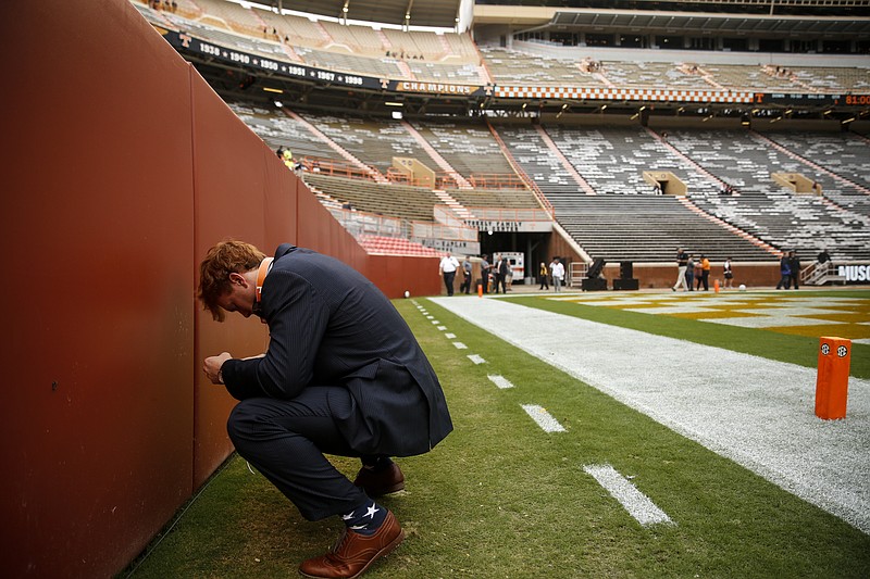 Tennessee linebacker Colton Jumper bows his head at the end-zone wall before leaving the field to suit up for the Vols' SEC conference football game against Georgia at Neyland Stadium on Saturday, Oct. 10, 2015, in Knoxville, Tenn.
