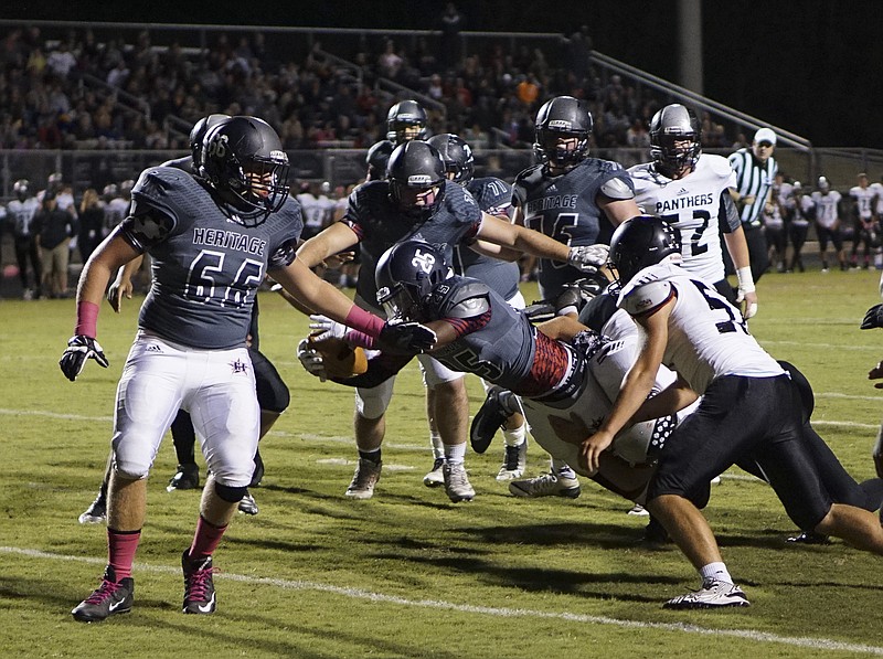 Staff Photo by Dan Henry / The Chattanooga Times Free Press- 10/16/15. Heritage High School's Lavarius Hood (25) dives into the end zone to score a touchdown against Ridgeland High School at the General's home field in Ringgold, Ga., on Friday, October 16, 2015. 