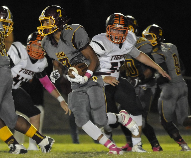 Tyner running back Chaysen Patrick (7) breaks through the line for yardage as Meigs defenders try to adjust in first half action at Tyner.