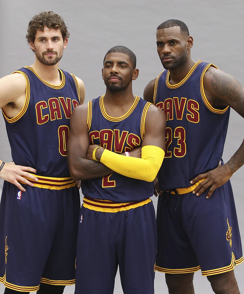 
              FILE - This Monday, Sept. 28, 2015, file photo shows Cleveland Cavaliers' Lebron James, right, Kyrie Irving, center, and Kevin Love posing for a portrait during the NBA team's media day in Independence, Ohio. Although James and the Cavs begin this season as odds-on favorites to defend their Eastern Conference title, they're a shell of themselves. Irving remains sidelined following surgery, Love was only recently cleared for practice. (AP Photo/Ron Schwane, File)
            