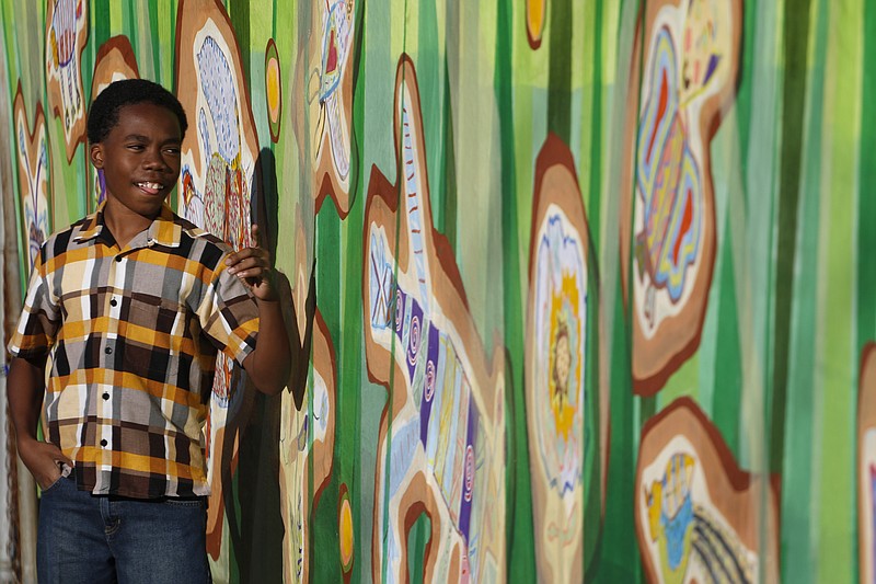 Staff Photo by Dan Henry / The Chattanooga Times Free Press- 10/16/15. Thirteen-year-old Yeshua Ruffin-Douglas stands in front of a new mural titled "Pollinators" on Friday, October 16, 2015 that he contributed to at Hope for the Inner City in East Chattanooga. 