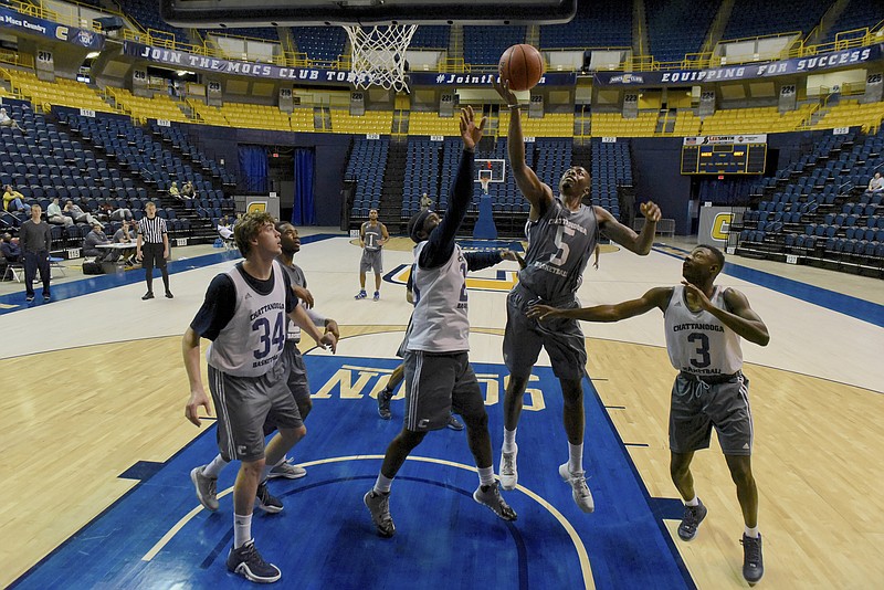 Justin Yuoyo (5) grabs an offensive rebound while, from left, Jackson White, Duke Ethridge and ZaQwaun defend as the UTC men's basketball team holds a scrimmage at McKenzie Arena on Sunday, Oct. 18, 2015, in Chattanooga, Tenn.