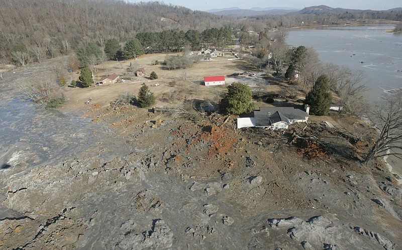 FILE - In this Dec. 22, 2008 file photo, an aerial view shows homes that were destroyed when a retention pond wall collapsed at the Tennessee Valley Authorities Kingston Fossil Plant in Harriman, Tenn.  No one was physically hurt in the Dec. 22, 2008, spill of coal ash from a Tennessee Valley Authority plant storage pond into the Emory River and across some 300 acres in the picturesque Swan Pond community about 35 miles west of Knoxville. But property owners in the area say they have been hurt financially.  (AP Photo/Wade Payne, File)