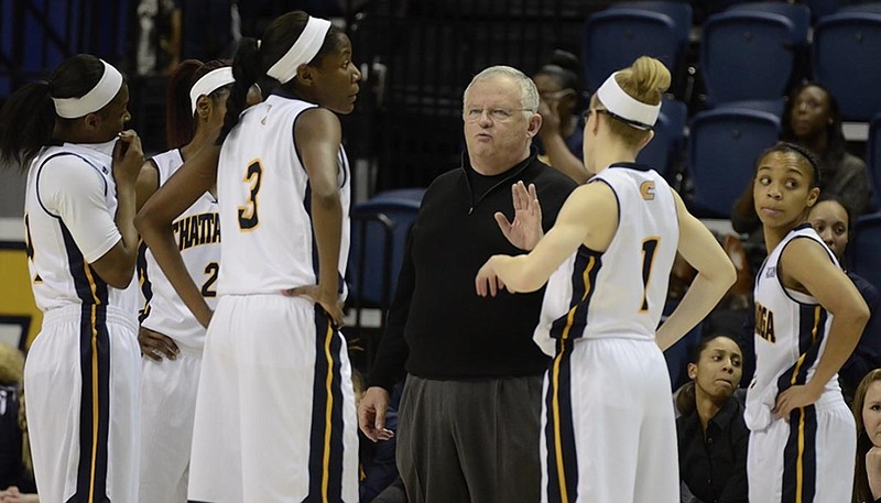 UTC women's basketball coach Jim Foster talks to his players during a game last season.