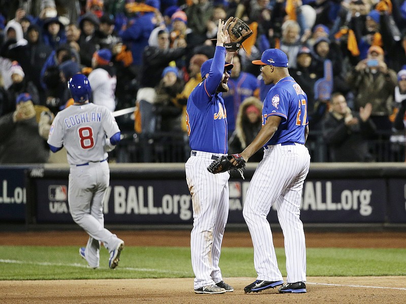 New York Mets' Daniel Murphy and Jeurys Familia celebrate after Chicago Cubs' Chris Coghlan (8) grounded out to end Game 2 of the National League baseball championship series Sunday, Oct. 18, 2015, in New York. The Mets won 4-1 to take a 2-0 lead in the series.