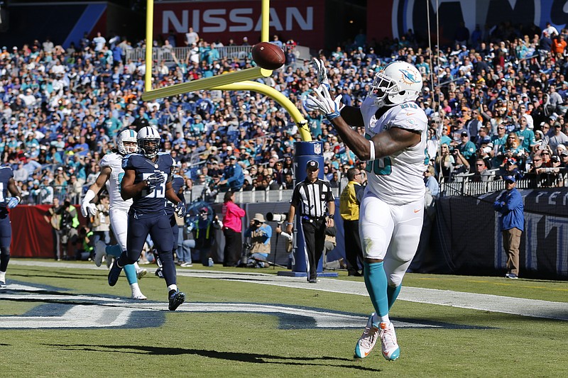 Miami Dolphins tight end Dion Sims (80) catches a 2-yard touchdown pass against the Tennessee Titans in the second half of an NFL football game Sunday, Oct. 18, 2015, in Nashville, Tenn. 