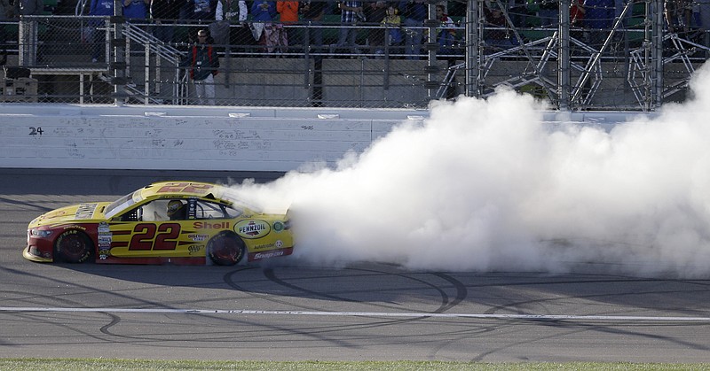 Sprint Cup Series driver Joey Logano burns out after winning a NASCAR auto race at Kansas Speedway in Kansas City, Kan., Sunday, Oct. 18, 2015. 