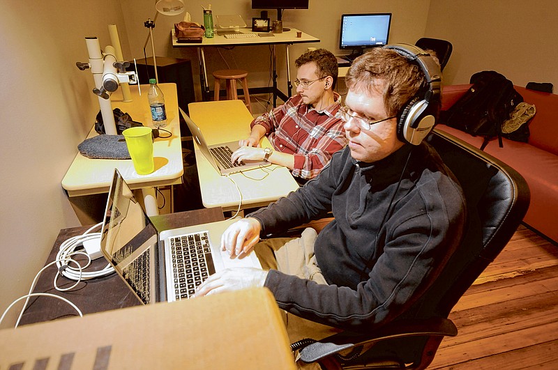 Employees work at the new Ambition company located at 800 Market St. next to the Lamp Post Group.