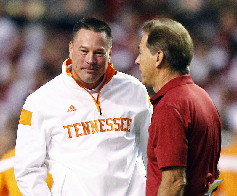 Tennessee coach Butch Jones, left, talks with Alabama head coach Nick Saban before an NCAA college football game Saturday, Oct. 25, 2014, in Knoxville.