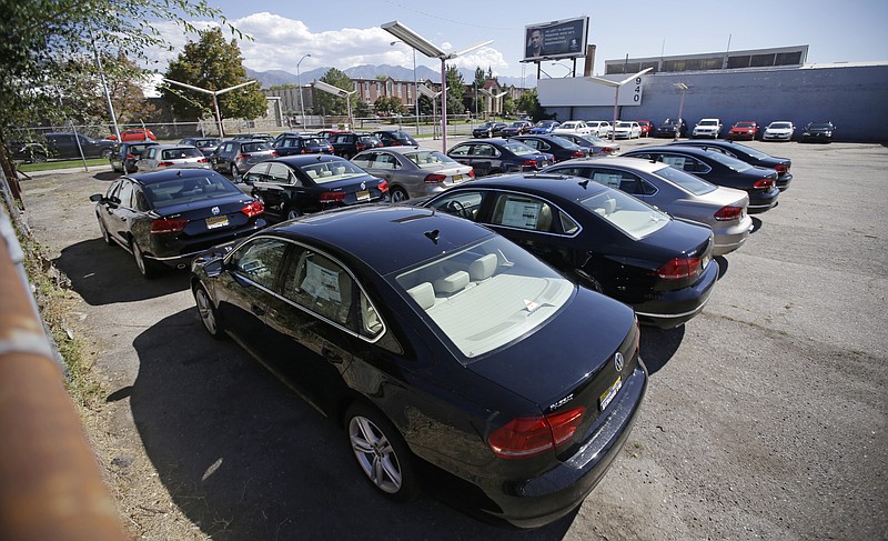 FILE - In this Sept. 23, 2015 file photo, Volkswagen diesel cars are parked in a storage lot near a VW dealership in Salt Lake City. Volkswagen almost inevitably will have to compensate owners of diesel cars equipped with emissions-rigging software. Some legal experts say the automaker could be forced to buy back the cars altogether. (AP Photo/Rick Bowmer, File)