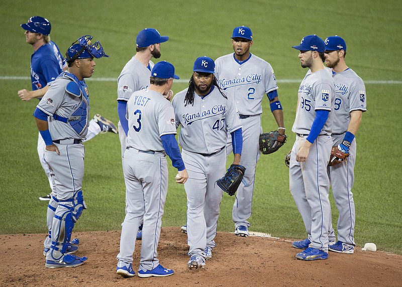
              Kansas City Royals starting pitcher Johnny Cueto, center, walks off the mound after handing the ball to manager Ned Yost (3) during the third inning in Game 3 of baseball's American League Championship Series against the Toronto Blue Jays on Monday, Oct. 19, 2015, in Toronto. (Darren Calabrese/The Canadian Press via AP) MANDATORY CREDIT
            