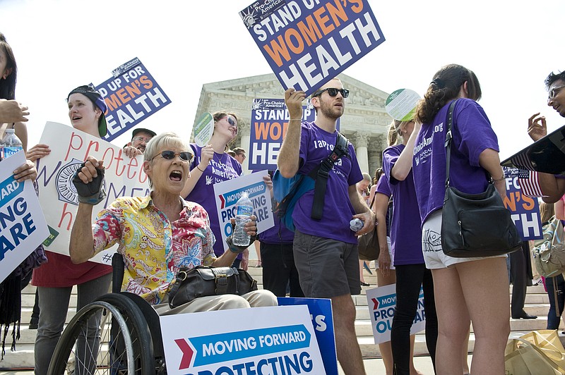 People voice their support for the Affordable Care Act at the Supreme Court in Washington, D.C., in 2012, as it considered the legality of the law's individual mandate.