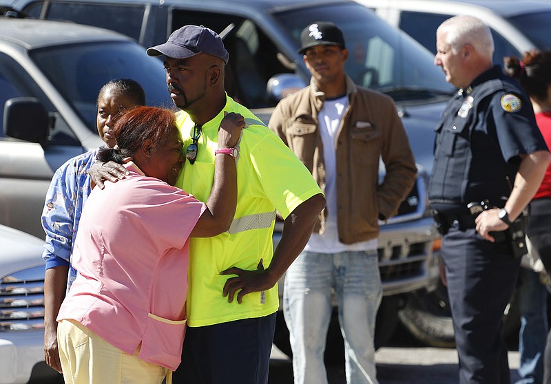 Staff Photo by Dan Henry / The Chattanooga Times Free Press- 10/20/15. Sylvia Peoples-Fuller, left, embraces her husband Marvin Fuller after finding out that Sylvia's son was murdered inside a home on 4th Avenue around 1 p.m. today.