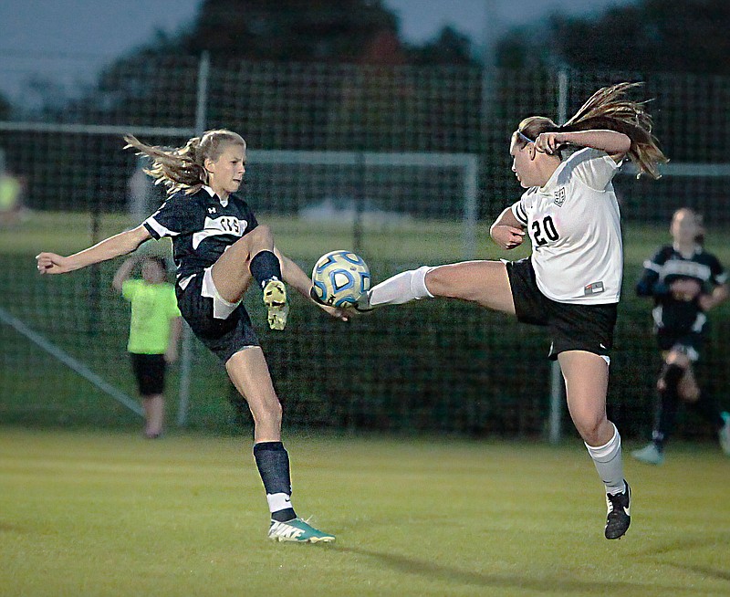 Chattanooga Christian's Sofie James, left, vies for the ball with Central Magnet's Alex Shea during CCS's 1-0 Region 4-A/AA semifinal win Tuesday night in Murfreesboro.