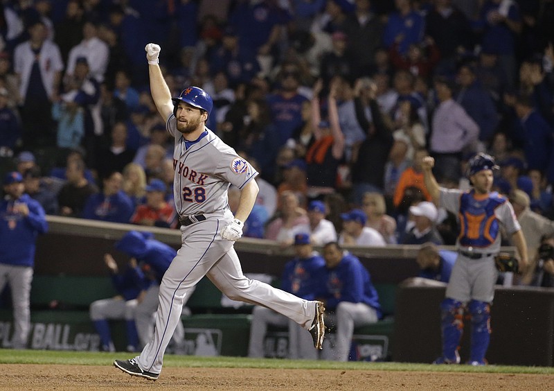 New York Mets' Daniel Murphy celebrates after hitting a two-run home run during the eighth inning of Game 4 of the National League baseball championship series against the Chicago Cubs Wednesday, Oct. 21, 2015, in Chicago. 