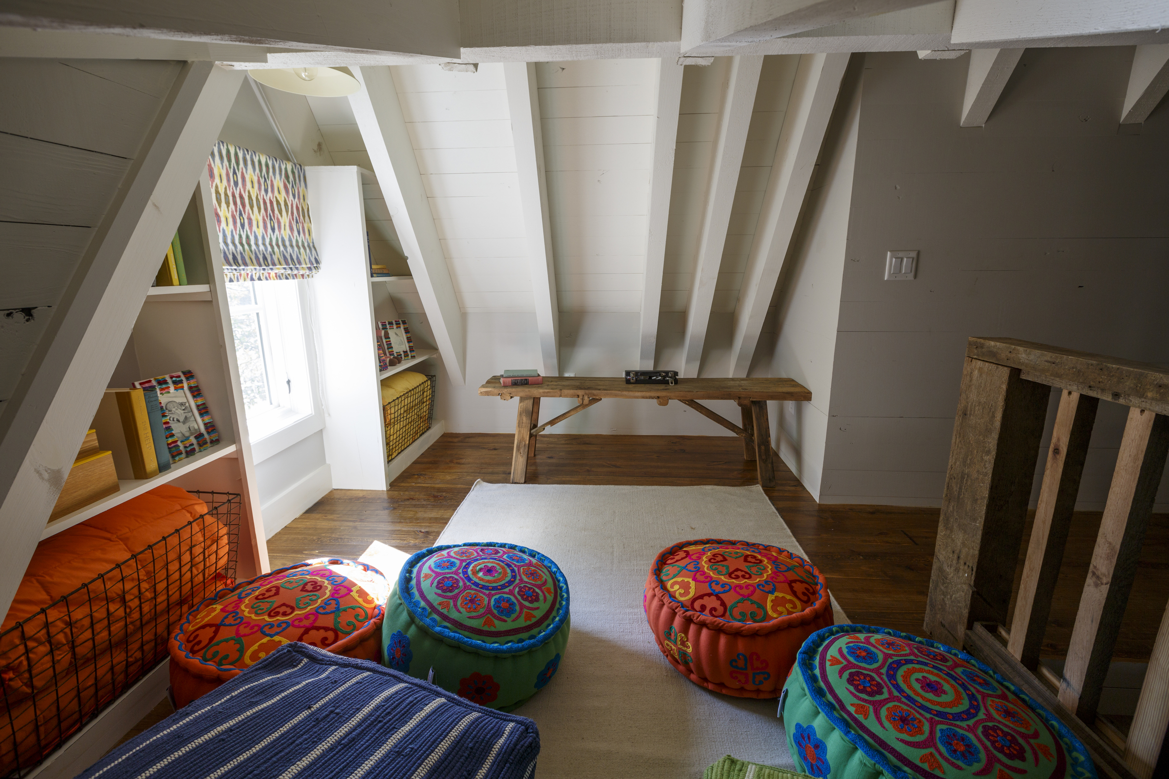 The cottage's loft has a child's bedroom with a small sitting room decorated with child-sized poufs for hanging out.