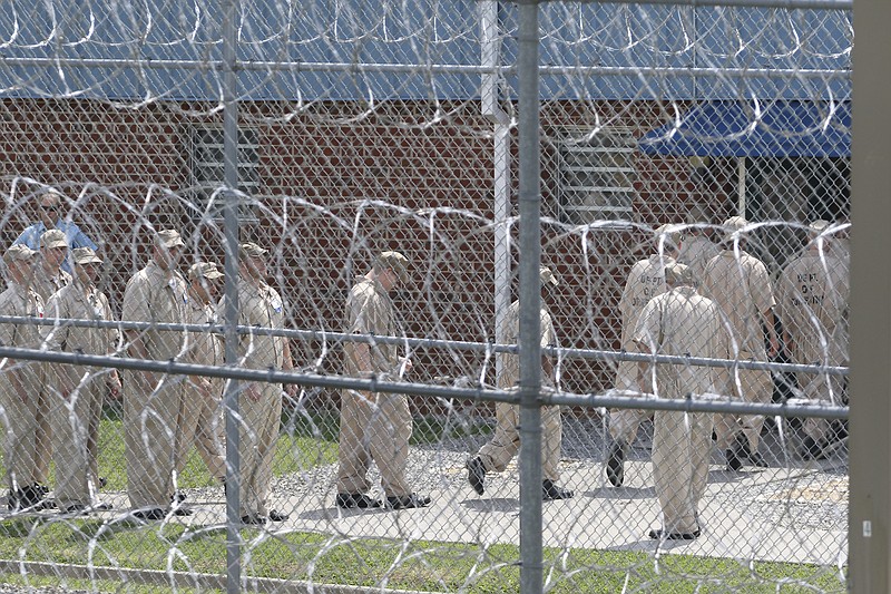 Inmates walk in formation outside of Georgia's Walker State Prison.