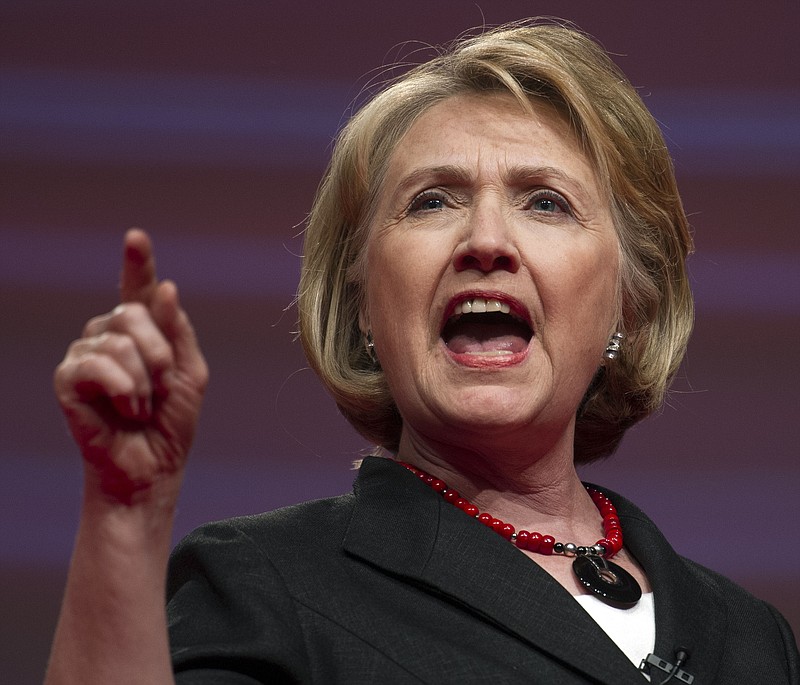 Former Secretary of State Hillary Rodham Clinton, shown addressing a convention in Washington, D.C., had to walk a tightrope in Thursday's hearings on the 2012 massacre in Benghazi, Libya.