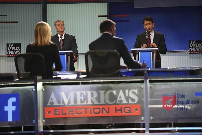 Sen. Lindsey Graham of South Carolina, left, and Gov. Bobby Jindal of Louisiana take part in the earlier of two Republican presidential primary debate in Cleveland on Aug. 6.