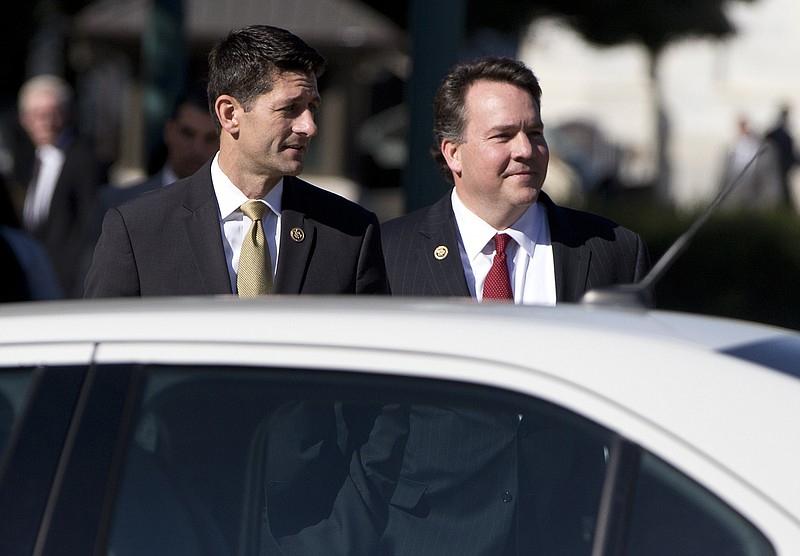 
              Rep. Paul Ryan, R-Wis., center, and Freedom Caucus member  Rep. Alex Mooney, R-W.Va., right, wait for the light to walk across Independence Avenue to the Longworth House Office Building on Capitol Hill in Washington, Wednesday, Oct. 21, 2015. Ryan seeking unity in a place it's rarely found, is telling House Republicans he will serve as their speaker only if they embrace him by week's end as their consensus candidate.  (AP Photo/Carolyn Kaster)
            