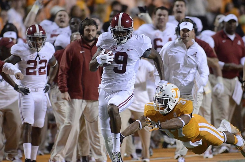 Alabama receiver Amari Cooper eludes the diving tackle attempt of Tennessee safety Brian Randolph on his way to the end zone during last year's game in Knoxville. While the Crimson Tide no longer have Cooper, who has moved on to the NFL, they have plenty of talent that will make it a challenge for the Volunteers to end Alabama's winning streak in the series.