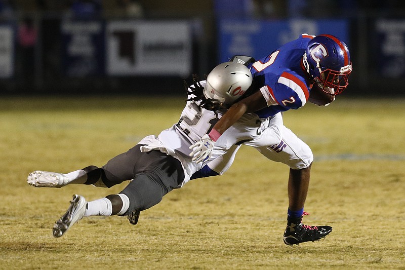 Staff Photo by Dan Henry / The Chattanooga Times Free Press- 10/23/15. Cleveland High School's Romeo Wykle (2) tries to shake Ooltewah High School's Adrian Hall (21) while playing at the Raiders' Benny Monroe Stadium on Friday, October 23, 2015. 