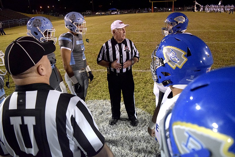 The referee instructs the team captains before the coin toss.  The Bledsoe County Warriors visited the Brainerd Panthers in TSSAA football action Friday night, October 23, 2015.