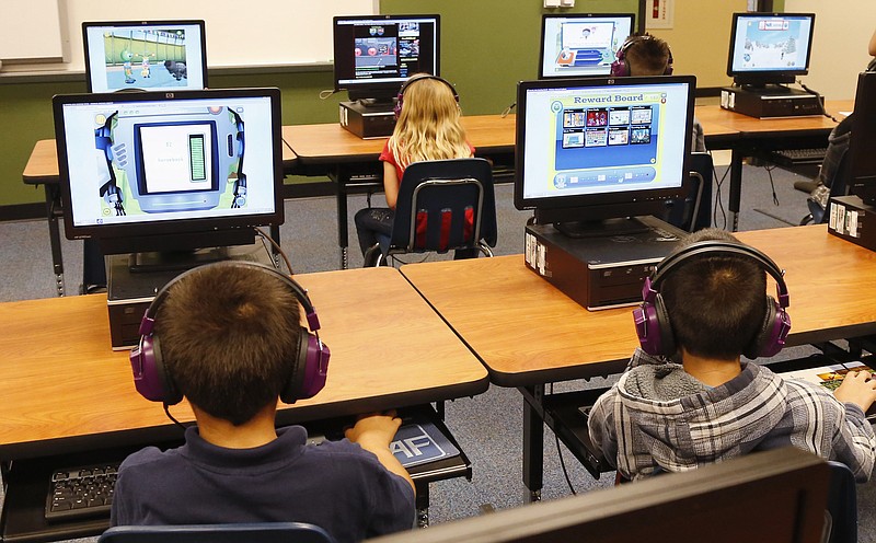 
              FILE - In this July 21, 2014 file photo, students at a summer reading academy at Buchanan elementary school work in the computer lab at the school in Oklahoma City. Wading into one of the most polarizing issues in education, President Barack Obama called Saturday for capping standardized testing at 2 percent of classroom time, while conceding the government shares responsibility for having turned tests into the be-all-and-end-all of American schools.  (AP Photo/Sue Ogrocki,File)
            