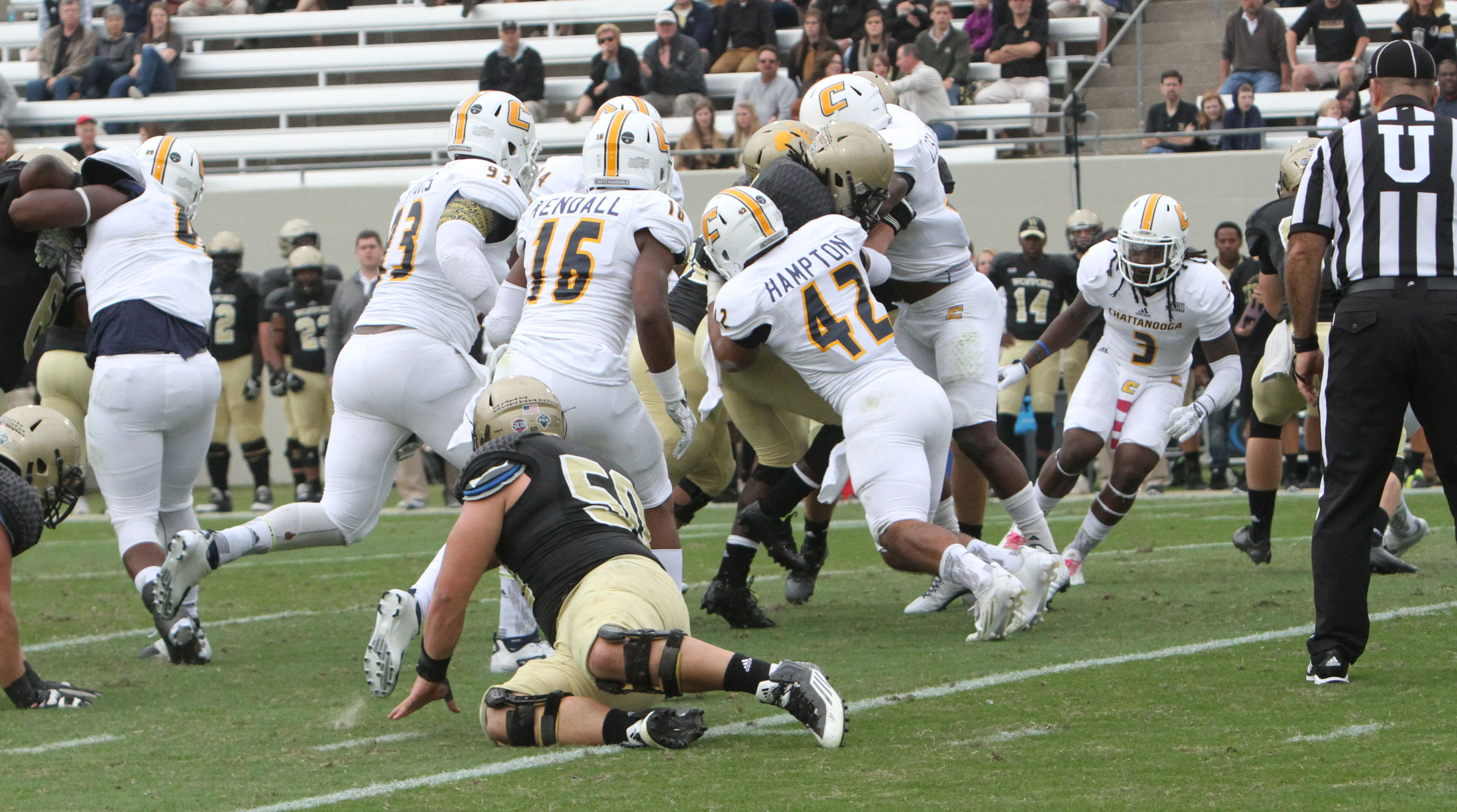 UTC's defense Keeionta Davis (93), Sema'je Kendall (16) and A.J. Hampton (42) against Wofford