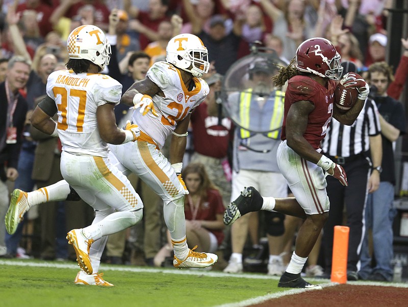 Alabama running back Derrick Henry (2) outruns Tennessee linebacker Darrin Kirkland Jr. (34) and defensive back Brian Randolph (37) for the go ahead touchdown during the second half of an NCAA college football game, Saturday, Oct. 24, 2015, in Tuscaloosa, Ala. Alabama won 19-14. (AP Photo/Butch Dill)