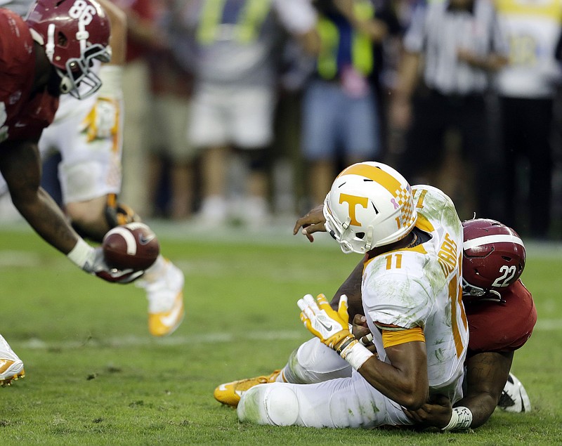 Alabama defensive lineman A'Shawn Robinson (86) recovers a fumble caused by the sack of Tennessee  quarterback Joshua Dobbs (11) by Alabama linebacker Ryan Anderson (22) during the second half of an NCAA college football game, Saturday, Oct. 23, 2015, in Tuscaloosa, Ala. (AP Photo/Butch Dill)