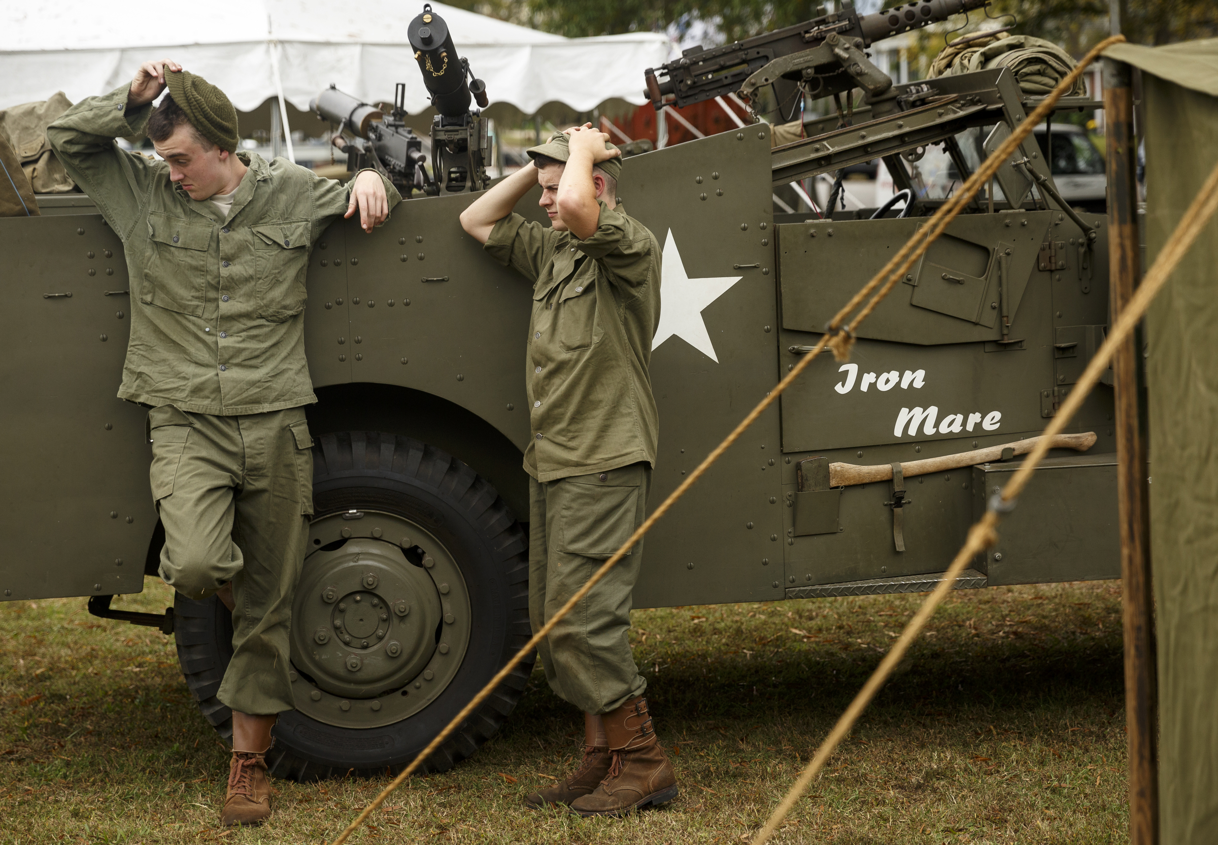 Justin Koenig, left, and James Decker lean against an M3A1 scout car in the U.S. camp at the 6th Cavalry Museum's 6th annual Remembering Our Heroes event on Saturday, Oct. 24, 2015, in Fort Oglethorpe, Ga. The event featured one World War II battle re-enactment, but the second re-enactment was changed to a firing demonstration after lower spectator turnout.