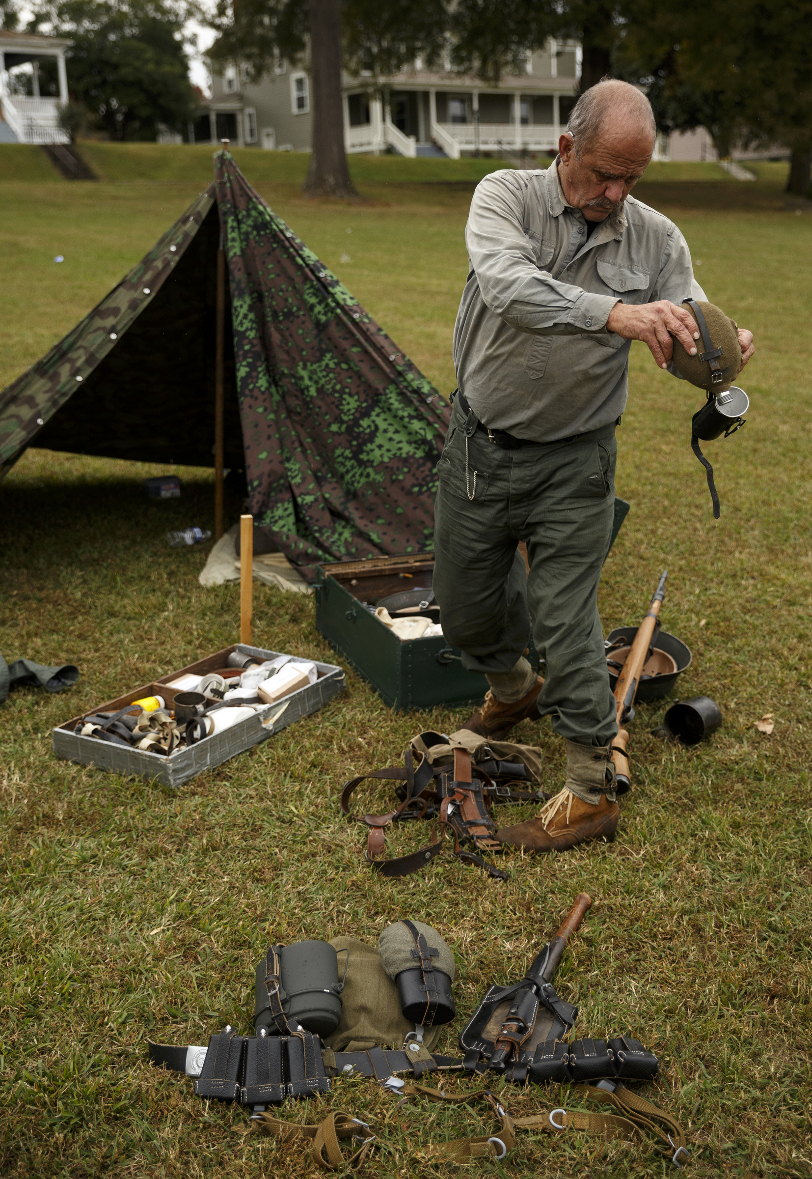 Ron Orange empties his canteen as he packs up his gear in the German camp at the 6th Cavalry Museum's 6th annual Remembering Our Heroes event on Saturday, Oct. 24, 2015, in Fort Oglethorpe, Ga. The event featured one World War II battle re-enactment, but the second re-enactment was changed to a firing demonstration after lower spectator turnout.