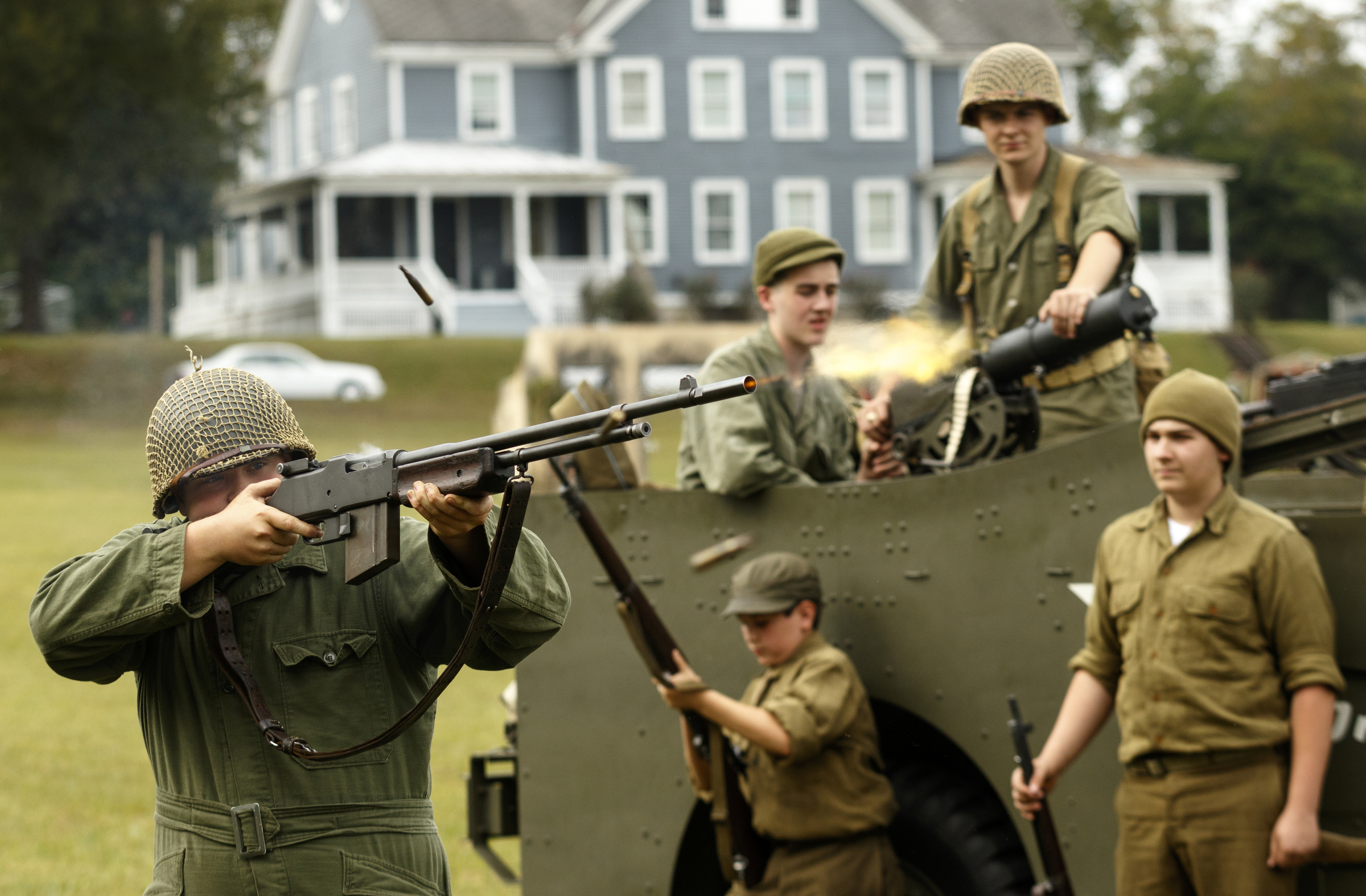 Other re-enactors watch as Jonathan Martin fires a Browning automatic rifle, or BAR, during a demonstration at the 6th Cavalry Museum's 6th annual Remembering Our Heroes event on Saturday, Oct. 24, 2015, in Fort Oglethorpe, Ga. The event featured one World War II battle re-enactment, but the second re-enactment was changed to a firing demonstration after lower spectator turnout.