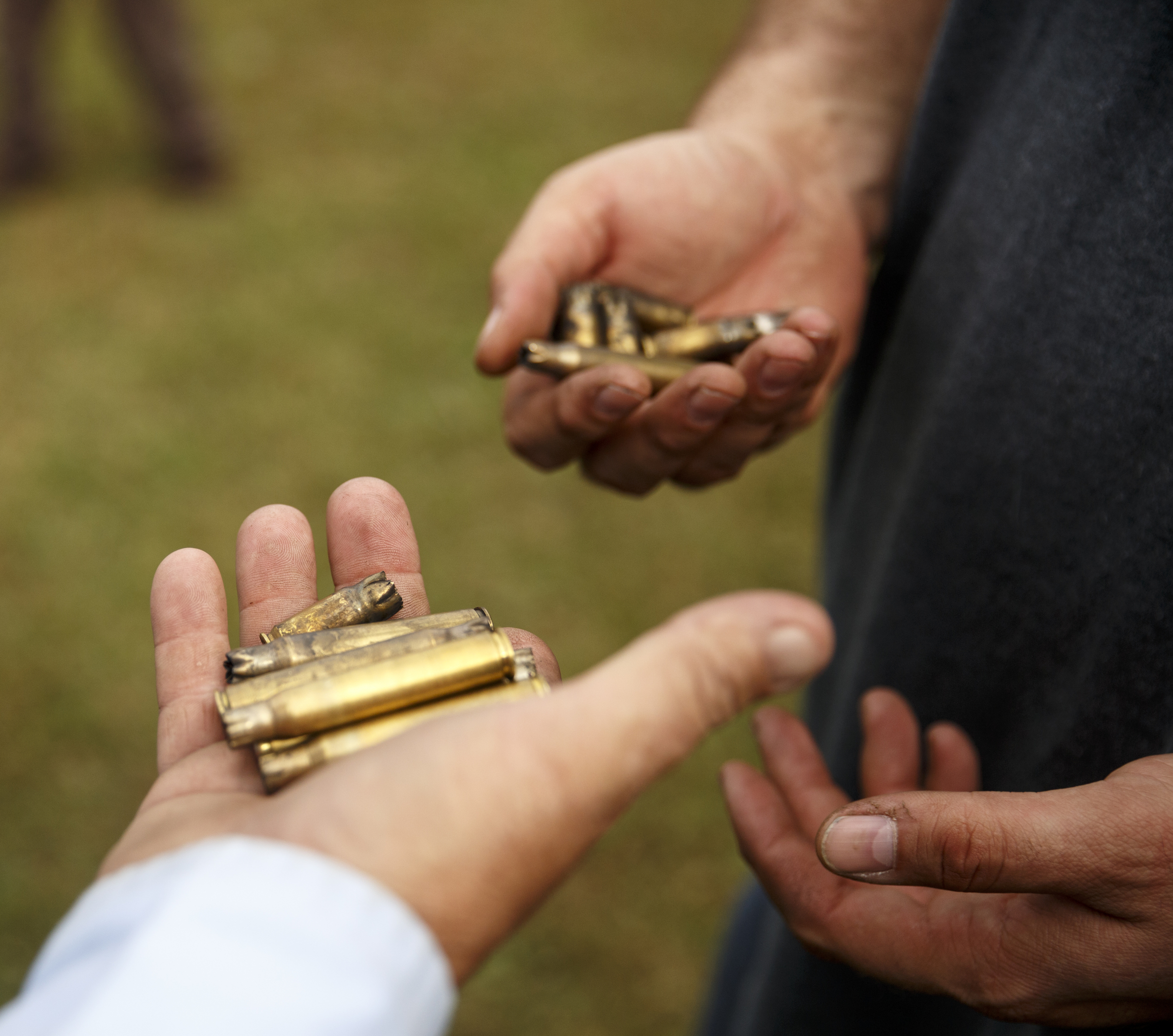Spectators pick up spent shells after a firing demonstration at the 6th Cavalry Museum's 6th annual Remembering Our Heroes event on Saturday, Oct. 24, 2015, in Fort Oglethorpe, Ga. The event featured one World War II battle re-enactment, but the second re-enactment was changed to a firing demonstration after lower spectator turnout.