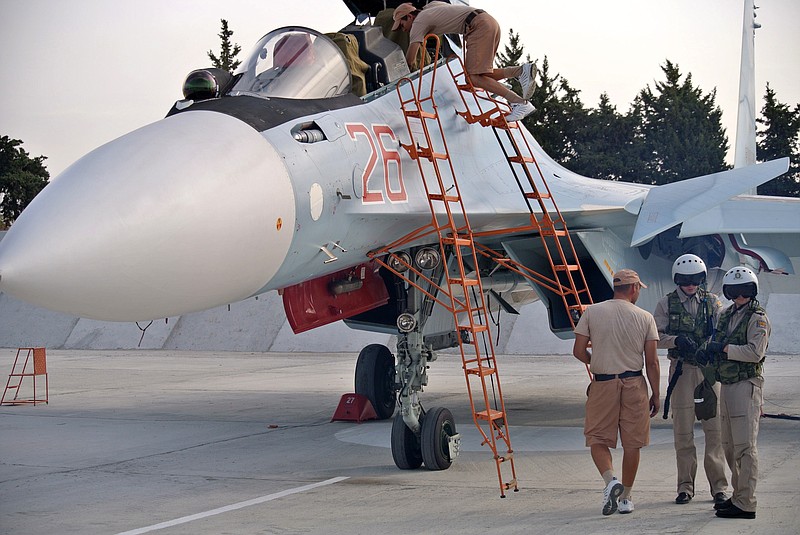 Russian air force crew stand next to a fighter jet in preparation for a combat mission at Hemeimeem airbase, Syria, on Oct. 22, 2015. Since early morning, Russian combat jets have been taking off from this base in western Syria, heading for missions. 