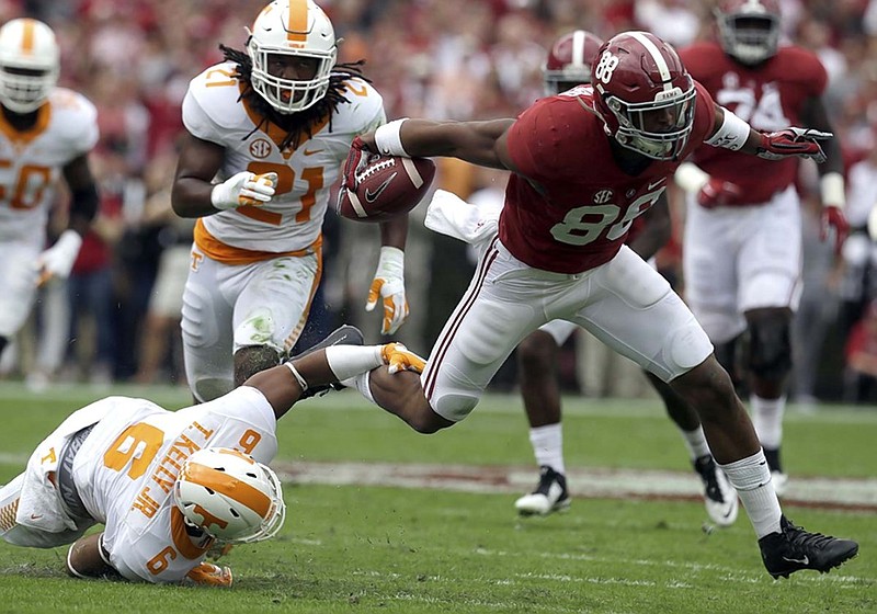 Alabama tight end O.J. Howard breaks free from the tackle of Tennessee defensive back Todd Kelly Jr. during Saturday's game in Tuscaloosa. The Crimson Tide will enjoy an open date before facing LSU, another top-10 team, on Nov. 7.