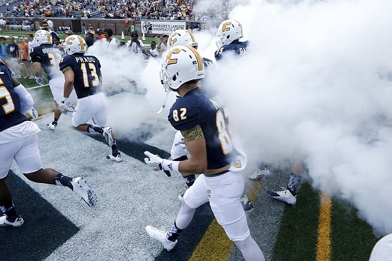 The UTC football team takes the field before the Mocs' football game against the Mars Hill Lions at Finley Stadium on Saturday, Sept. 12, 2015, in Chattanooga, Tenn. UTC won 44-34.