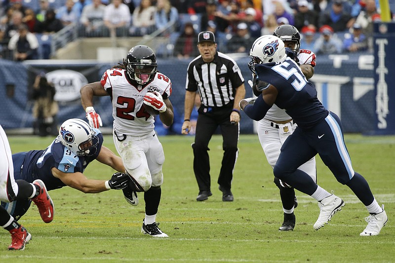 Atlanta Falcons running back Devonta Freeman (24) runs the ball against the Tennessee Titans in the second half of an NFL football game Sunday, Oct. 25, 2015, in Nashville, Tenn.