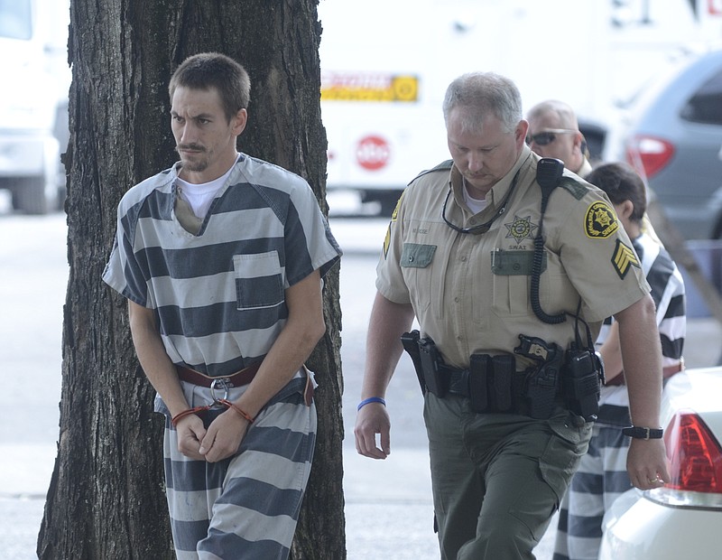 Matt Rose, right, with the Rhea County Sheriff's Department, walks Bradley Adcox into the Rhea County Courthouse before a preliminary hearing in the death of 5-year-old Landon Robbins.