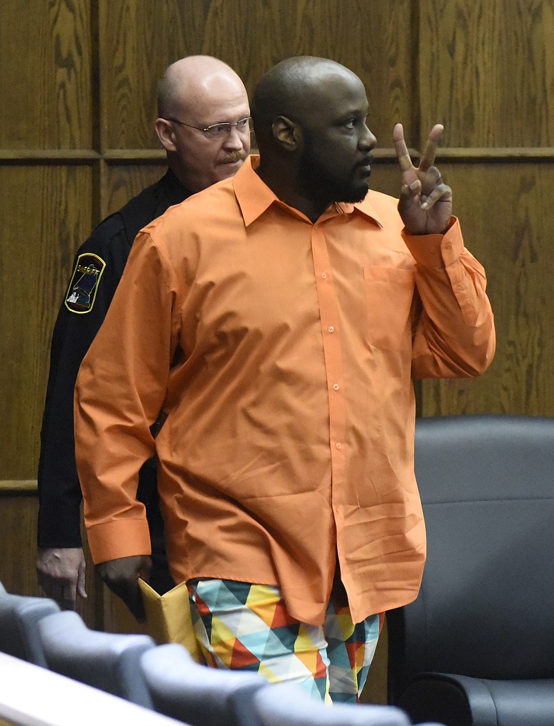 Santory Johnson gestures as he is led into the courtroom of Judge Tom Greenholtz as jury selection begins in his first-degree murder trial in the Hamilton County Criminal Court on Monday, Oct. 27, 2015, in Chattanooga, Tenn. Johnson faces charges in the shooting death of Christopher Jones, Jr., on Oct. 4, 2013.