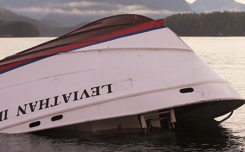 
              The bow of the Leviathan II, a whale-watching boat  that capsized on Sunday, is seen Tuesday, Oct. 27, 2015, near Vargas Island after it was towed it from where it sank to a protected spot behind an island, before it is towed ashore for inspection. Investigators are trying to unravel the mystery of what caused a whale watching boat to capsize off Vancouver Island in seemingly calm weather, killing five British nationals including a father and his teenage son. A search continued for a missing Australian man. Twenty-one people were rescued. (Chad Hipolito/The Canadian Press via AP)
            