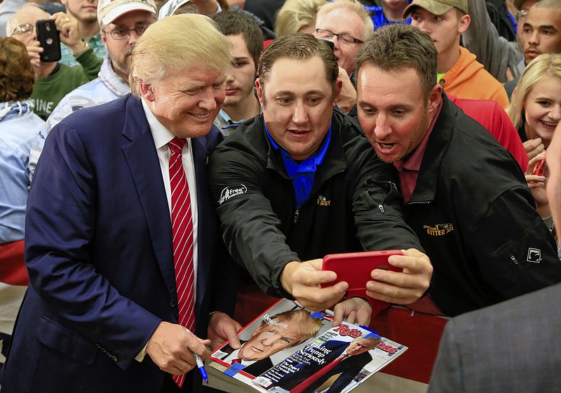 
              Republican presidential candidate Donald Trump takes a picture with supporters following a rally at West High School in Sioux City, Iowa, Tuesday, Oct. 27, 2015. (AP Photo/Nati Harnik)
            