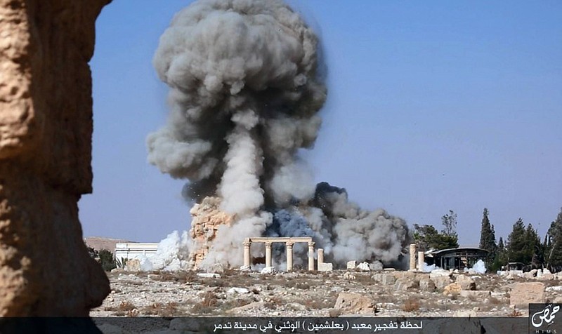 
              FILE - This undated photo released Tuesday, Aug. 25, 2015, file photo, on a social media site used by Islamic State militants, which has been verified and is consistent with other AP reporting, shows smoke from the detonation of the 2,000-year-old temple of Baalshamin in Syria's ancient caravan city of Palmyra. Activists say the Islamic State group in has killed three captives on Monday, Oct. 26, 2015 in Syria’s ancient city of Palmyra by tying them to Roman-era columns at the site, then blowing the structures up with explosives. (Islamic State social media account via AP, File)
            
