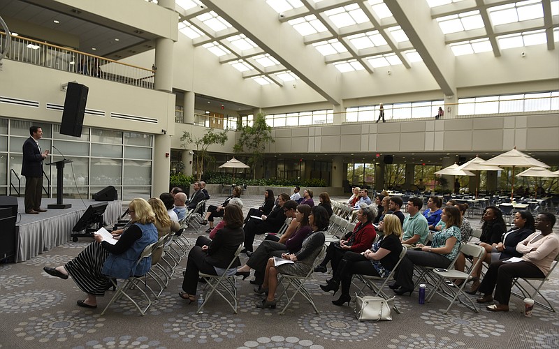 Graham Thomas of Tennessee Achieve speaks to Unum employees gathered at an event at the company's atrium on Tuesday, Oct. 28, 2015, in Chattanooga, Tenn., to encourage them to sign up to be mentors to help with Tennessee Promise and Tennessee Achieve. 