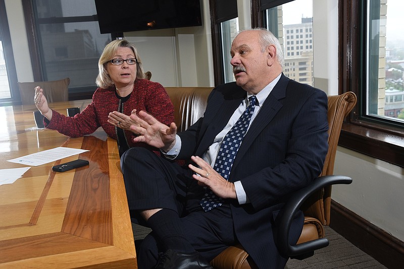 Rhonda Champion, left, and Mike Steele talk about the Affordable Care Act requirements for businesses in 2016.