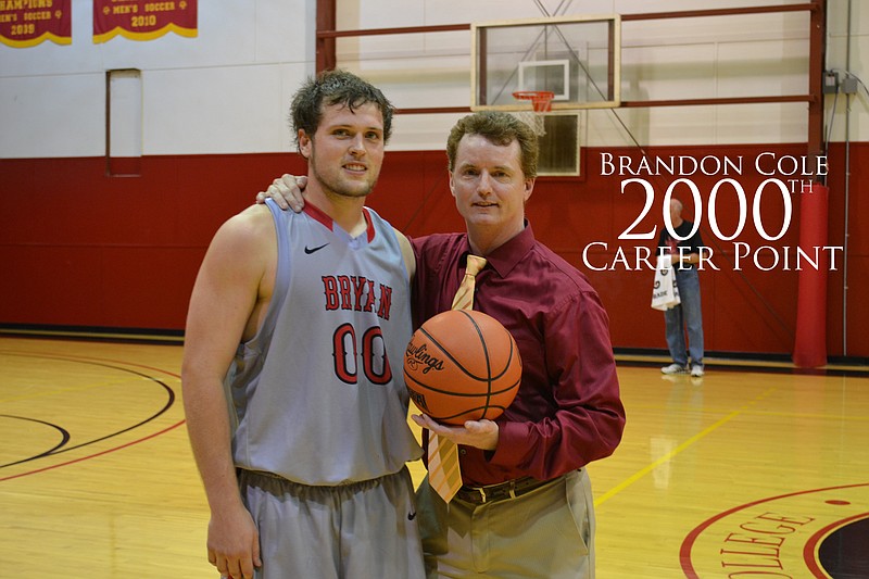 Bryan College senior Brandon Cole is congratulated by coach Don Rekoske for reaching the 2,000-point mark as a Lion. Cole is at 2,021 after scoring 37 points in the Lions' 97-94 season-opening loss to Oakwood University on Wednesday.