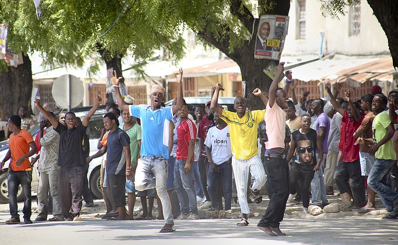 
              In this photo taken Monday, Oct. 26th, 2015 and made available Wednesday, Oct. 28th, 2015, youths supporting the opposition party dance and chant, predicting a win for their candidate, outside the Electoral Commission office in Stone Town, Zanzibar, a semi-autonomous island archipelago of Tanzania. Zanzibar's election commission chief announced Wednesday that the results of the island archipelago's presidential election have been nullified because of alleged irregularities, saying that the decision was taken because of several issues with the voting process, but did not say when another election would take place. (AP Photo)
            