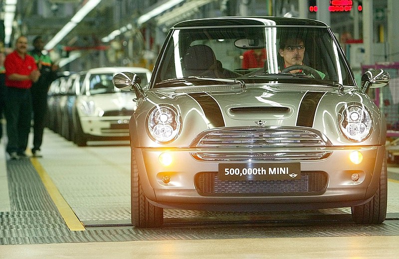 
              FILE - In this Aug. 25, 2004 file photo, The 500,000th Mini is driven off the production line at BMW Group Plant in Oxford, England.  Under pressure from U.S. safety regulators, on Wednesday, Oct. 28, 2015, BMW's Mini brand is recalling more than 86,000 cars because the power steering could fail. The recall covers the Mini Cooper and Cooper S models from 2002 to 2005.  (AP Photo/Dave Caulkin)
            